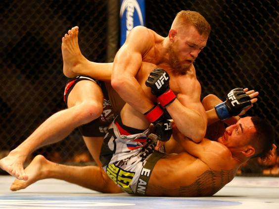McGregor fighting Holloway at UFC Boston in August 2013 Getty
